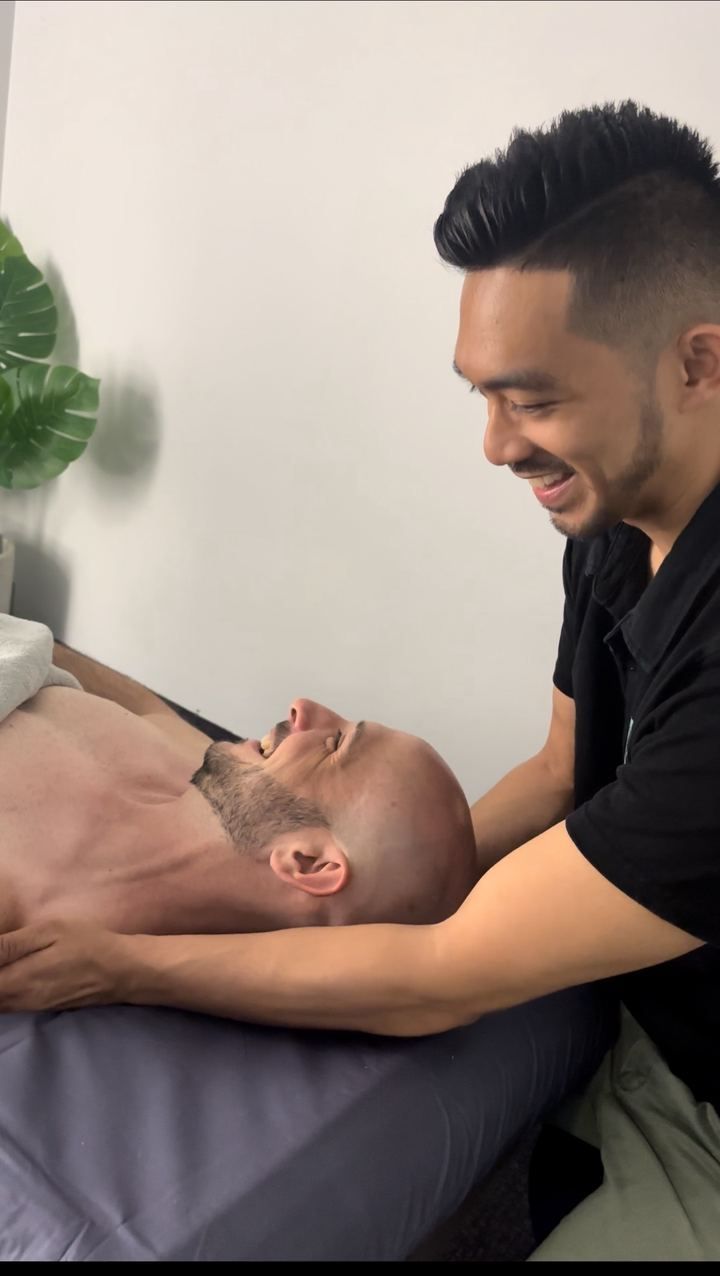 Joshua Milanes treating a patient's back at Strive Osteopathy